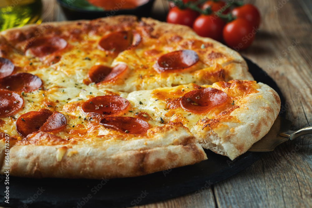 A slice of hot Italian pizza with stretching cheese. Pizza pepperoni on a dark wooden background A slice of hot Italian pizza with stretching cheese. Pizza pepperoni on a dark wooden background