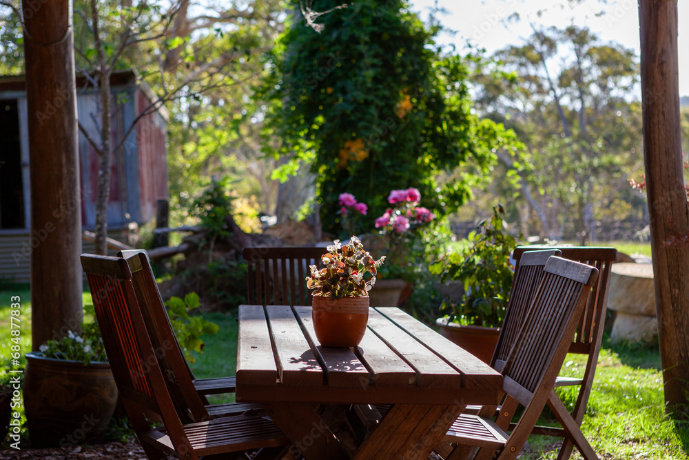 Obraz premium table and chairs in garden