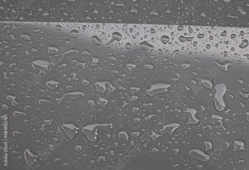 The gray metal surface had water droplets glistening on the surface.