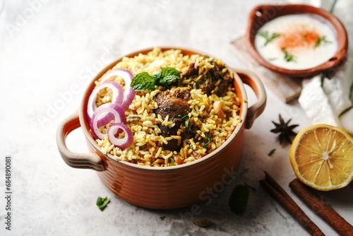 Homemade Chicken Dum biryani | Malabar Irachi choru served with Yogurt salad, selective focus photo