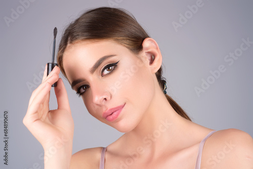 Female model shaping brown eyebrows. Woman eye with beautiful eyebrows. Perfect shaped brow, eyelashes with brow gel brush. Paint eyebrows.