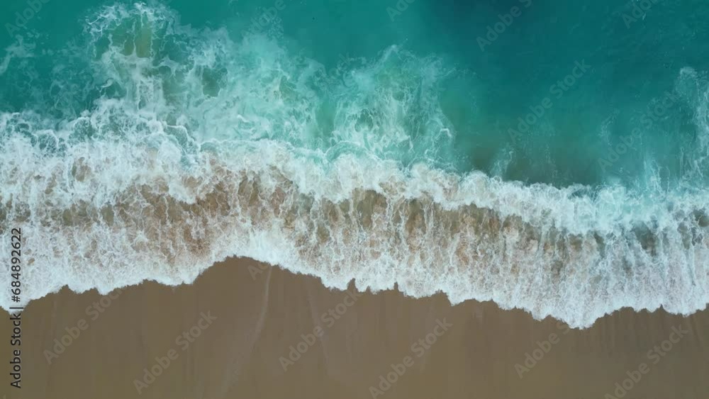 Top view of the los cabos beach in Mexico. Aerial drone footage of sea waves reaching shore in the coast.