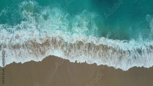 Top view of the los cabos beach in Mexico. Aerial drone footage of sea waves reaching shore in the coast.