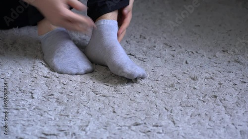 person holding a sock and put it on in the morning