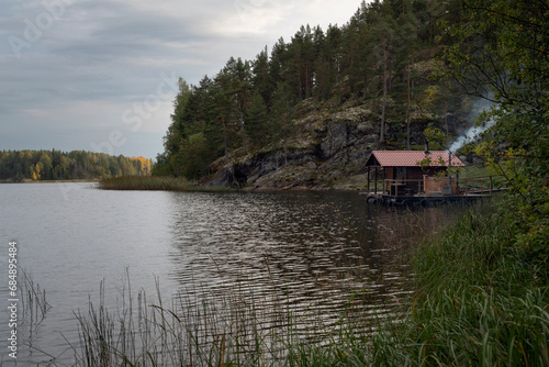 A melted bathhouse on the shore of Lake Ladoga near the village of Lumivaara on a sunny autumn day, Ladoga skerries, Lahdenpohya, Republic of Karelia, Russia