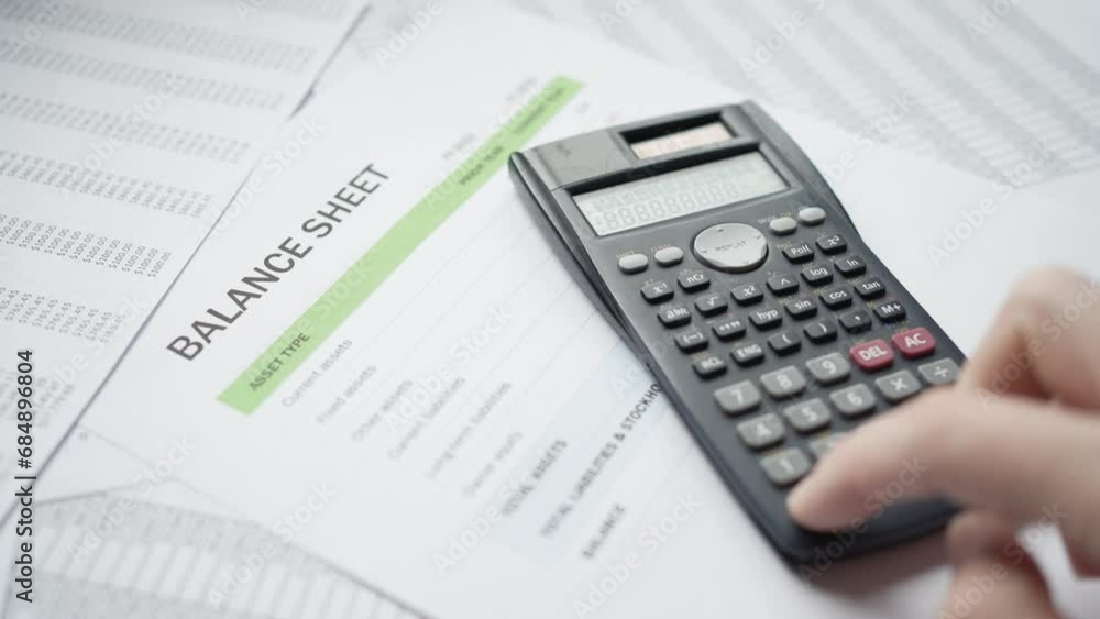 Balance Sheet Document With Calculator Being Used Closeup Balance Sheet Document With Calculator Being Used Closeup