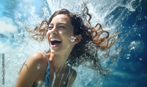 woman splashing water with a smile © Kien