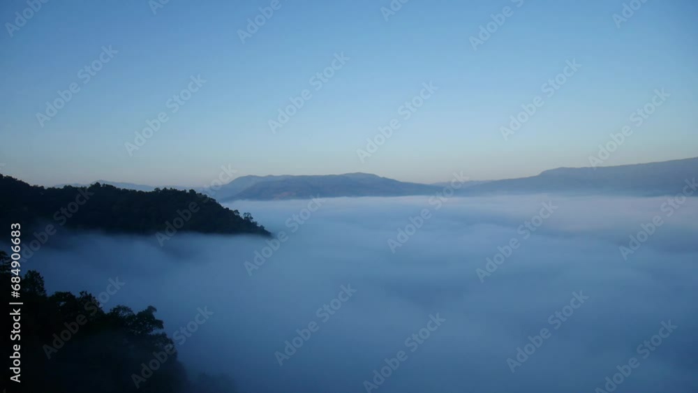 Beautiful sea of mist on the mountains in Thailand, The weather is hot and humid, with a lot of water vapor creating a sea of mist in the foreground in the valley, fog and clouds with mountain hill Beautiful sea of mist on the mountains in Thailand, The weather is hot and humid, with a lot of water vapor creating a sea of mist in the foreground in the valley, fog and clouds with mountain hill