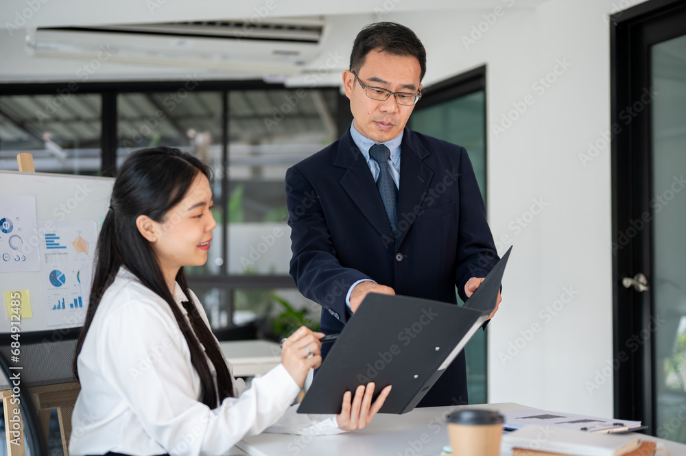 Professional team of business people working together in the office room, prepare for the next meeting.