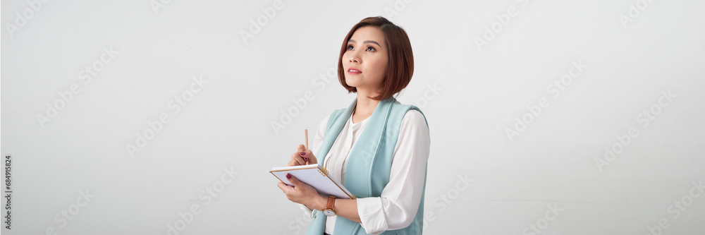 A happy asian businesswoman holding clipboard isolated over white banner background A happy asian businesswoman holding clipboard isolated over white banner background