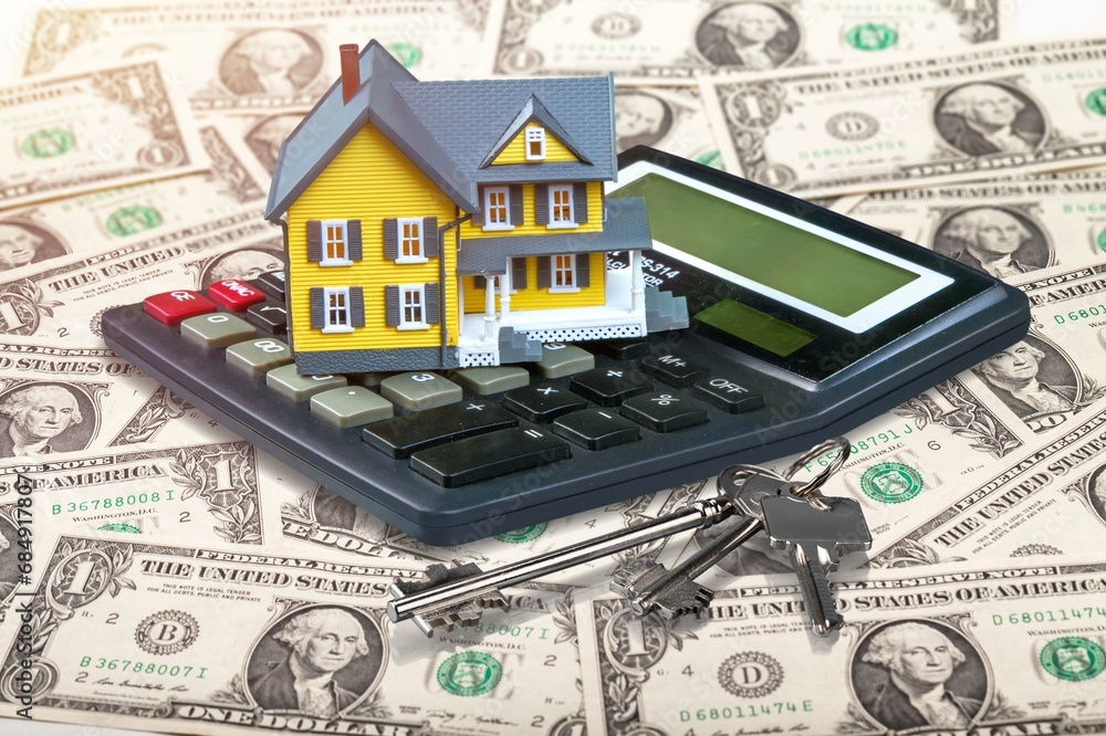Model house, office calculator, money notes Model house, office calculator, money notes