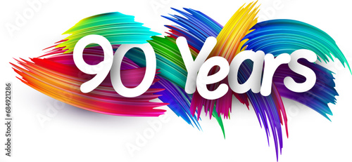90 years paper word sign with colorful spectrum paint brush strokes over white.
