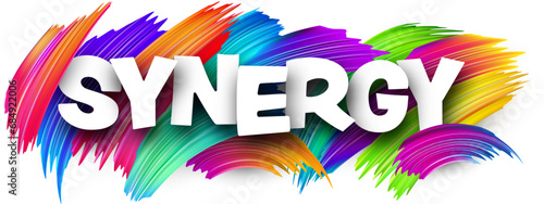 Synergy paper word sign with colorful spectrum paint brush strokes over white.
