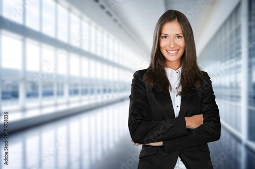 Confident professional business woman employee standing in office