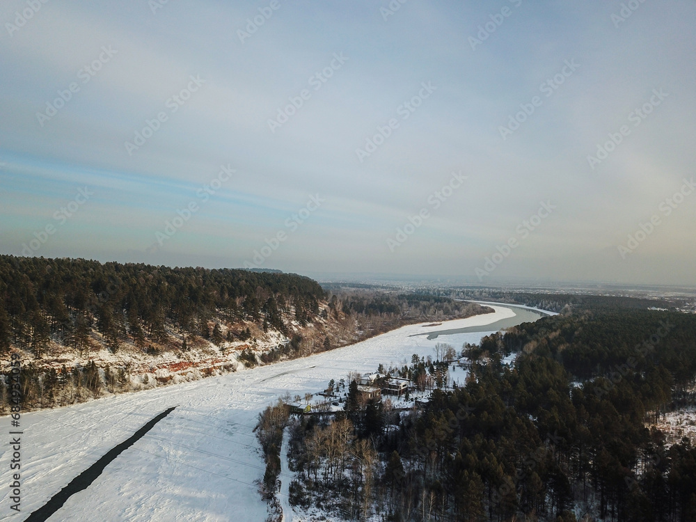 Winter landscape with a River and Winter Forest. aerial view from icy river in winter. Selective focus.
