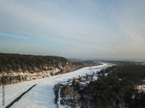 Winter landscape with a River and Winter Forest. aerial view from icy river in winter. Selective focus.