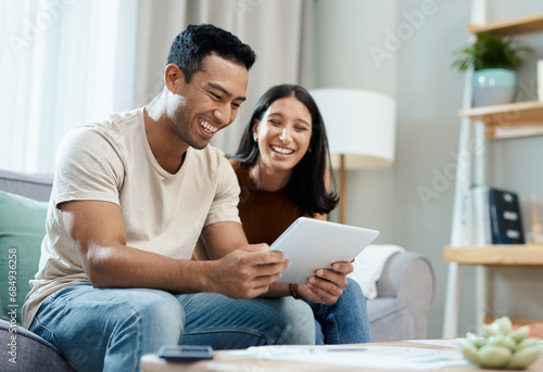Happy couple, tablet and social media on sofa in house for financial planning, budget or savings. Man, woman and smile for deal, offer or announcement with technology by internet, mobile app or web