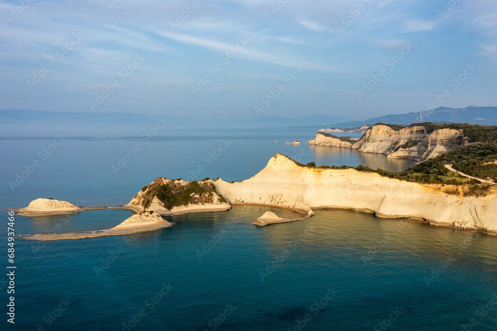 Beautiful view of Cape Drastis in the island of Corfu in Greece. Cape Drastis, the impressive formations of the ground, rocks and the blue waters panorama, Corfu, Greece, Ionian Islands. Beautiful view of Cape Drastis in the island of Corfu in Greece. Cape Drastis, the impressive formations of the ground, rocks and the blue waters panorama, Corfu, Greece, Ionian Islands.
