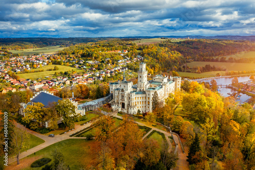 Castle Hluboka nad Vltavou is one of the most beautiful castles in Czech Republic. Castle Hluboka nad Vltavou in autumn with red foliage, Czechia. Colorful autumn view of Hluboka nad Vltavou castle.