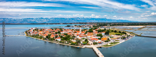 Fototapeta Naklejka Na Ścianę i Meble -  Historic town of Nin laguna aerial view with Velebit mountain background, Dalmatia region of Croatia. Aerial view of the famous Nin lagoon and medieval in Croatia