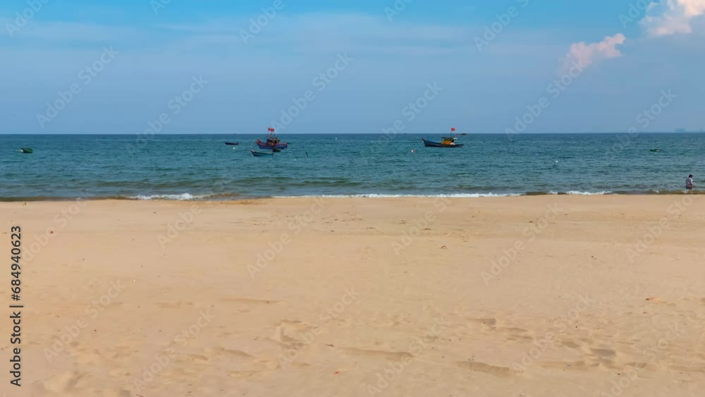 Two Vietnamese Fishing Boats Anchored Floating Off Shore In Clean Empty Beach During Clear Daytime