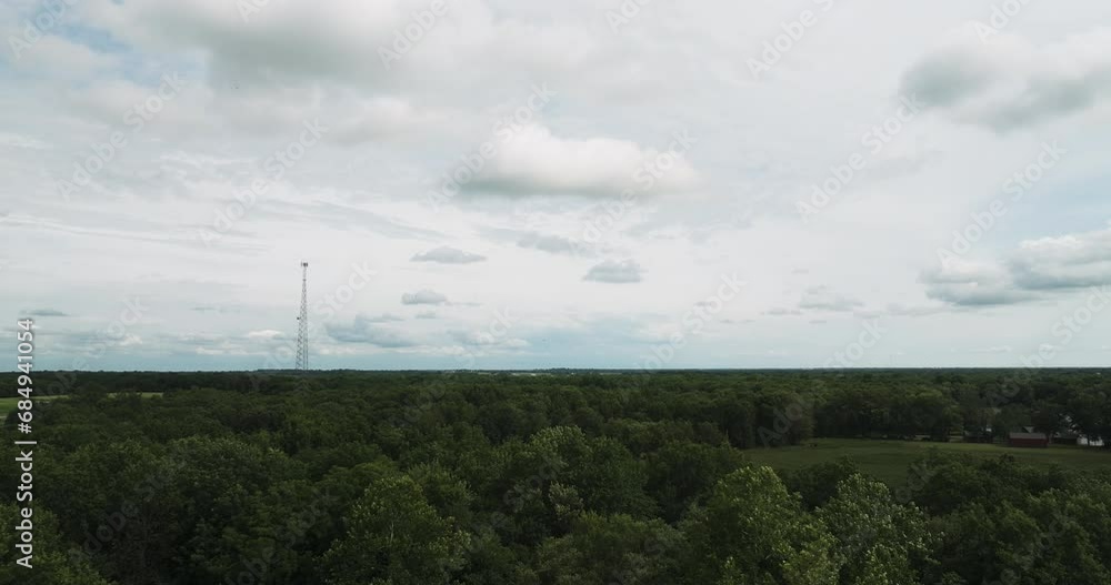Transmission Tower Over Dense Thicket Near Lamar, Barton County, Missouri, United States. Aerial Wide Shot Transmission Tower Over Dense Thicket Near Lamar, Barton County, Missouri, United States. Aerial Wide Shot