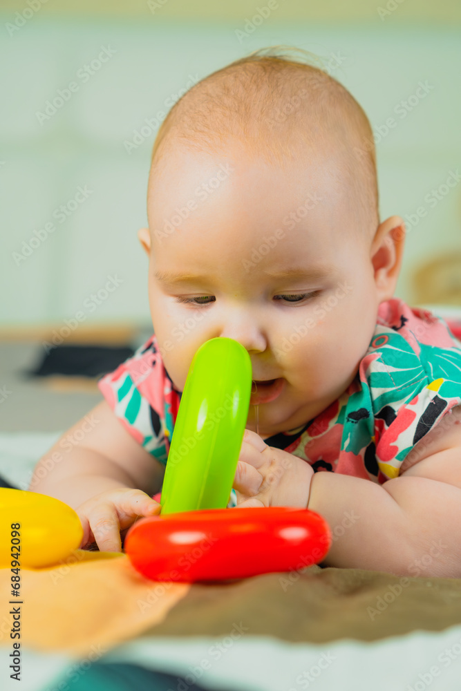 Portrait of a cute baby girl playing with colorful toys at home Portrait of a cute baby girl playing with colorful toys at home