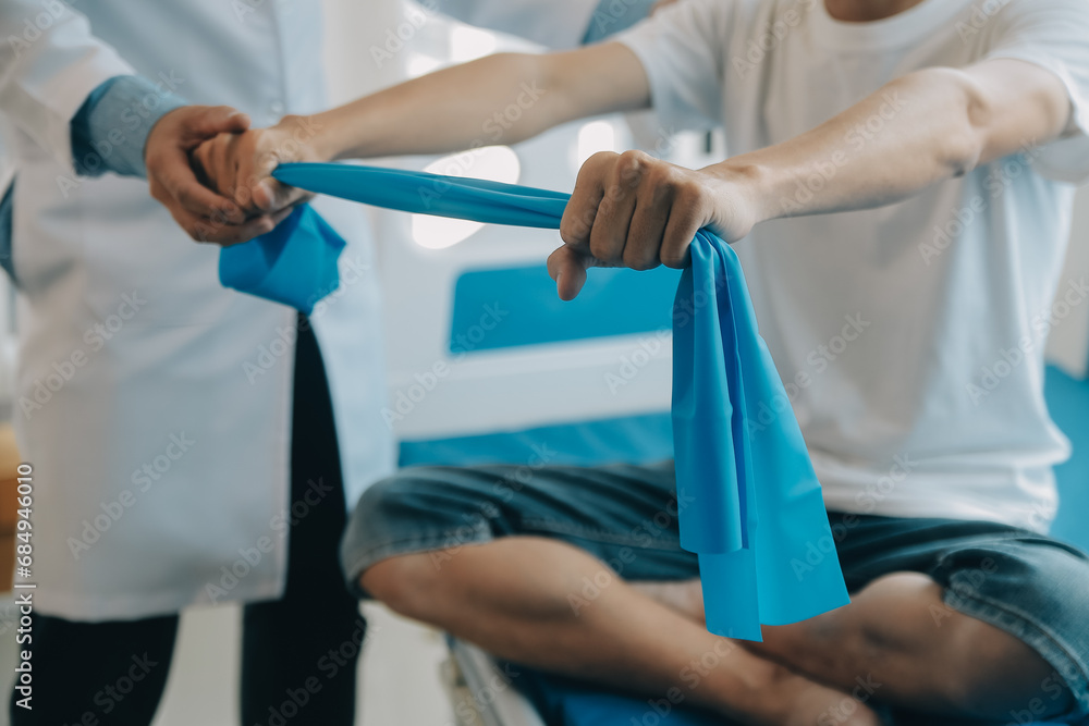 Doctor or physical therapist examines back pain and spinal area to give advice within the rehabilitation center. Doctor or physical therapist examines back pain and spinal area to give advice within the rehabilitation center.