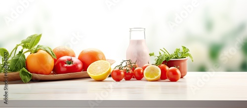 In an abstract depiction of a kitchen, a closeup of fresh, de-focused tomatoes and oranges, combined with other organic ingredients, symbolizes healthy and organic cooking. Isolated on a white photo
