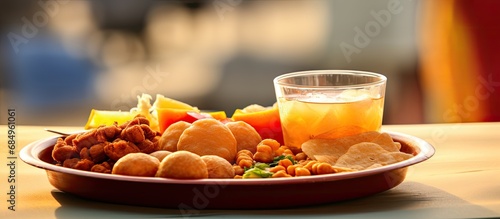 During the Countryn festival, a plate of mouthwatering Panipuri chat with crispy puri, spicy potato and chickpeas, tangy tamarind chutney and flavorful masala sauce is served alongside refreshing photo