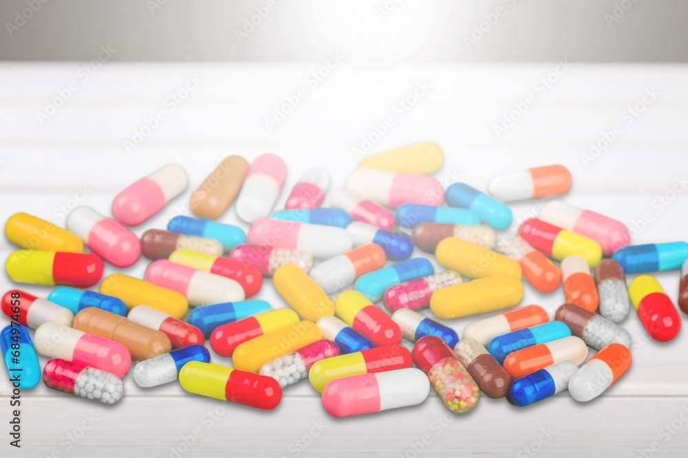 Pills medical capsules in different colors on desk Pills medical capsules in different colors on desk
