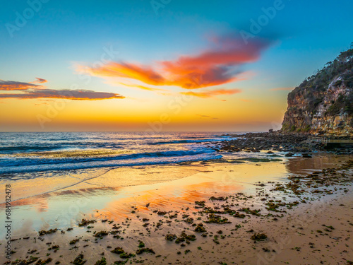 Sunrise at the seashore with colour in the clouds