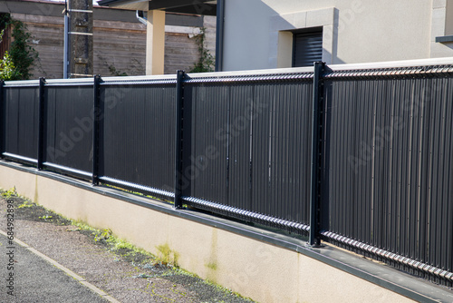 Fototapeta Naklejka Na Ścianę i Meble -  barrier wooden fender wall gey steel fence of suburb house facade