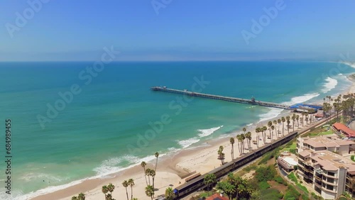 Metrolink Train Passing By The Beach With San Clemente Pier In Summer In San Clemente, California, USA. - aerial photo