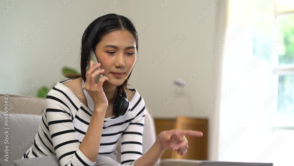 Consulent speaking to mobile cellphone at home office. women speak with remote clients using phone. Laptop on the desk. Home office smart working concept lifestyle. Consulent speaking to mobile cellphone at home office. women speak with remote clients using phone. Laptop on the desk. Home office smart working concept lifestyle.