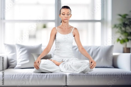Young female meditating sitting at home Free Download Young female meditating sitting at home - GFXLoad
