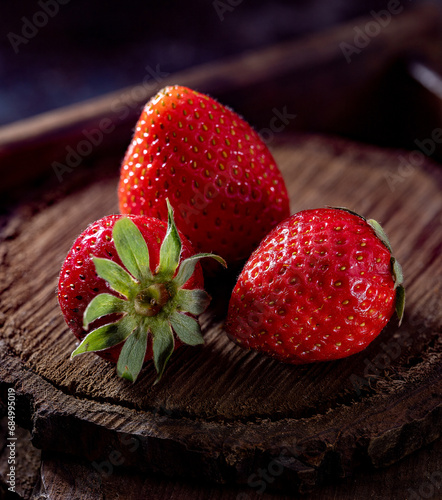 Fresh strawberries on wooden board macro