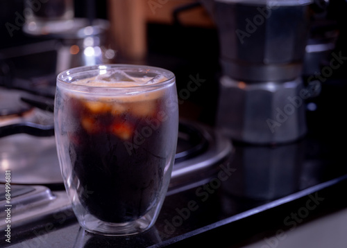 fresh espresso into a glass with ice cubes. Fresh ice coffee, espresso, with thick, soft crema foam to mix with water to make an Americano. Brew coffee from Arabica and Robusta beans.