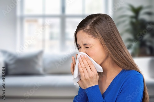 sick young woman sneezing with allergy or flu