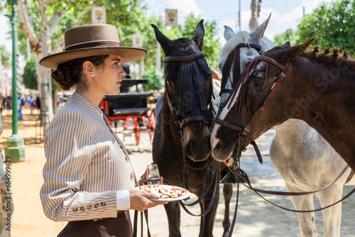 Serious elegant woman with horse in countryside