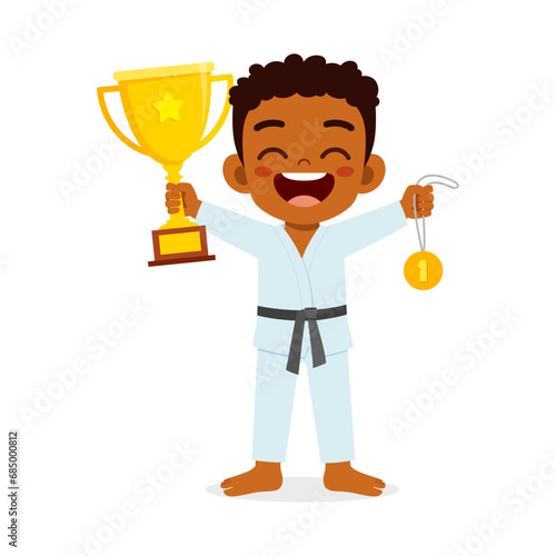 little kid holding trophy winning in sport