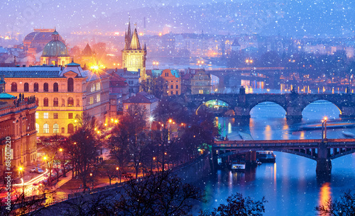 Evening over river Vltava near Charles bridge in Prague, Czech republic. Winter snow landscape