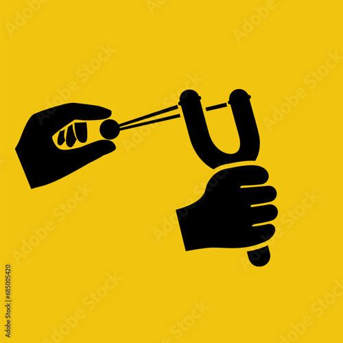 Slingshot in hand black icon. The man holds a wooden slingshot in his hand and pulls the elastic band. Vector illustration flat design. Isolated on yellow background.