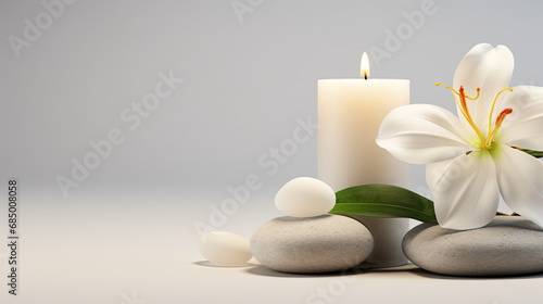 a white candle, flowers and stones. spa concept. relaxation