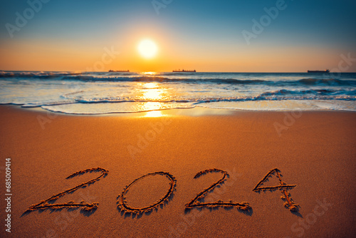 Fototapeta Naklejka Na Ścianę i Meble -  Happy New Year 2024 concept, lettering on the beach. Sea sunrise