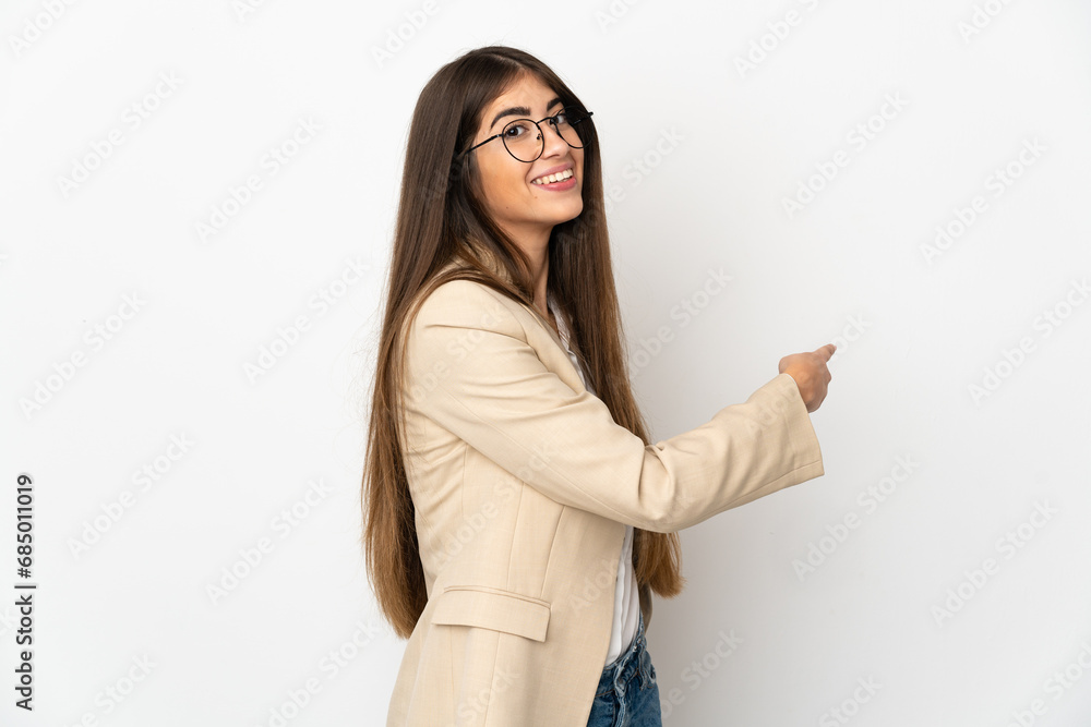 Young caucasian woman isolated on white background pointing back Young caucasian woman isolated on white background pointing back