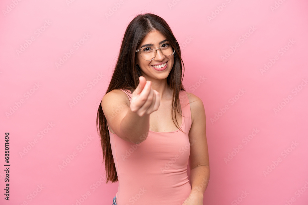 Young caucasian woman isolated on pink background making money gesture Young caucasian woman isolated on pink background making money gesture