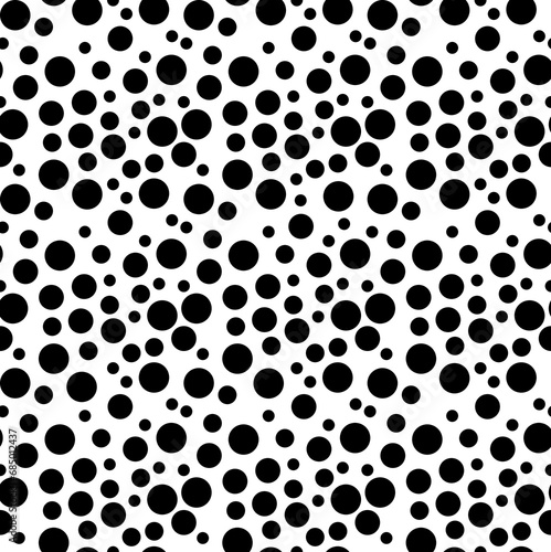 Background with monochrome irregular dotted texture. Polka dot pattern. photo