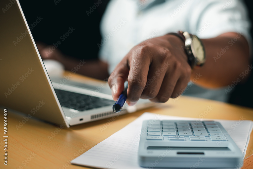 Business accounting concept, businessman using calculator with laptop computer Ready to write a summary of the organization's annual income.
Business accounting concept, businessman using calculator with laptop computer Ready to write a summary of the organization's annual income.