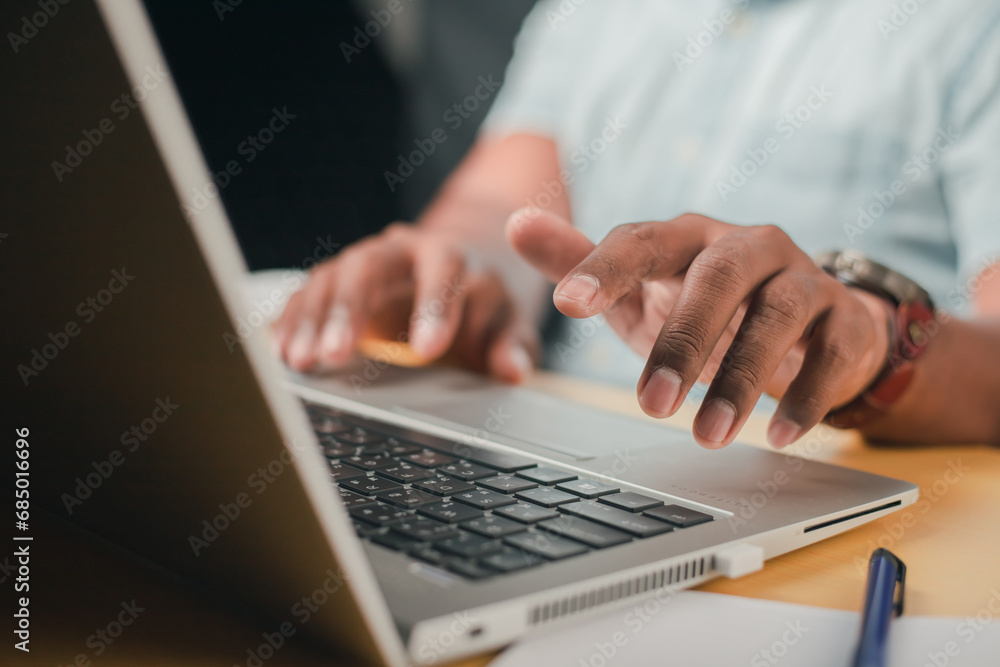 A business man is checking daily online stock market prices through a laptop at home with graphs displayed on the screen. Concept of daily business uncle A business man is checking daily online stock market prices through a laptop at home with graphs displayed on the screen. Concept of daily business uncle